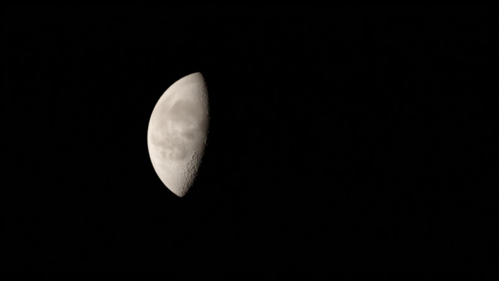 A first quarter Moon showing crater shadows along the terminator