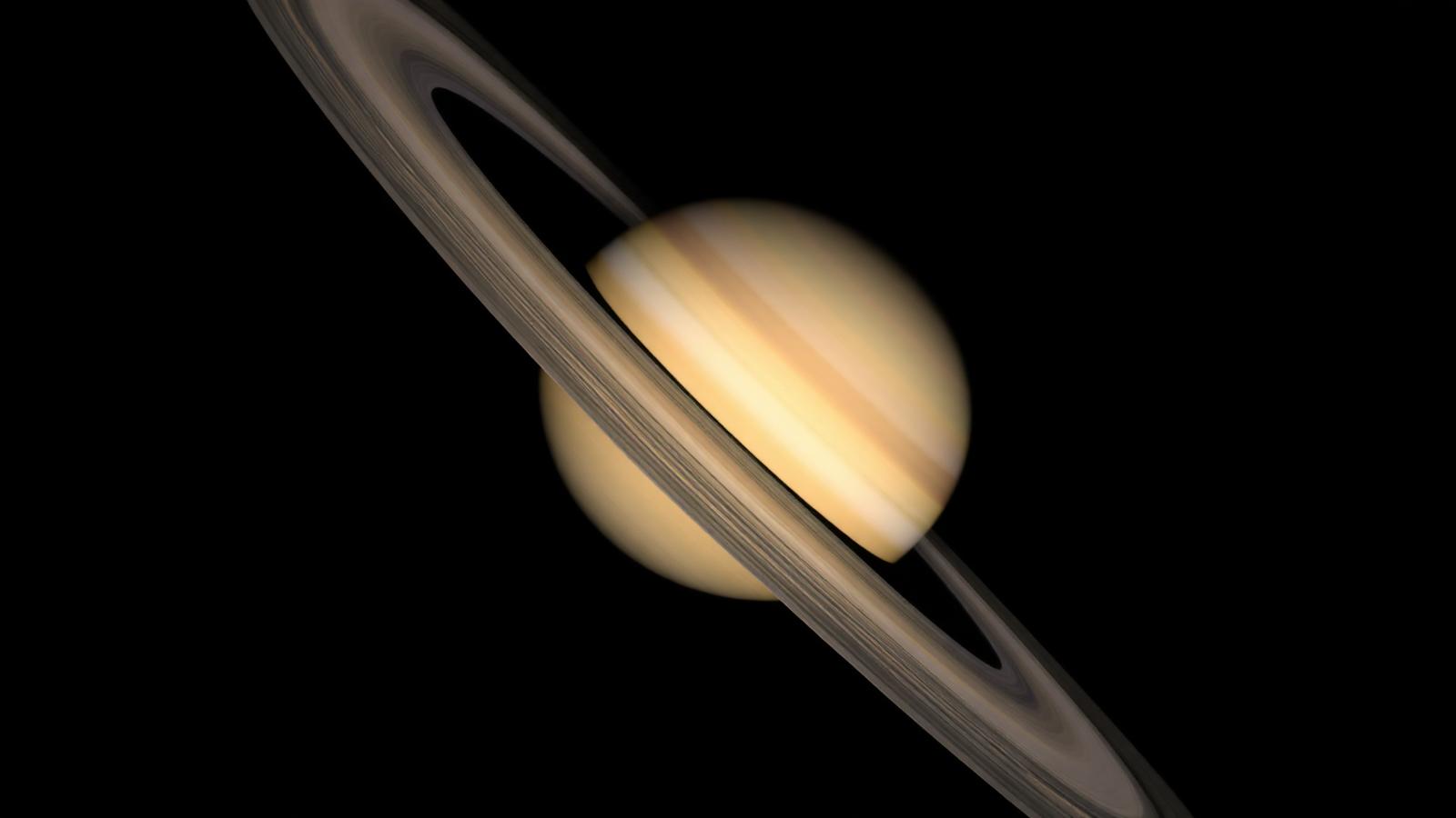 Close-up of Saturn showing rings tilted nearly edge-on as a thin bright line